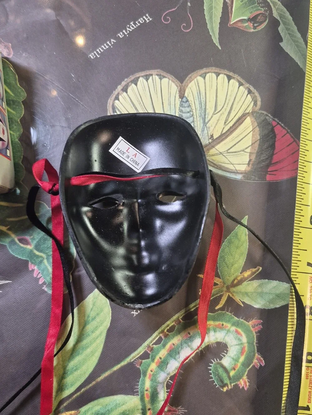 Black and Gold Decorative Venetian-Style Mask with Red & Black Ribbons